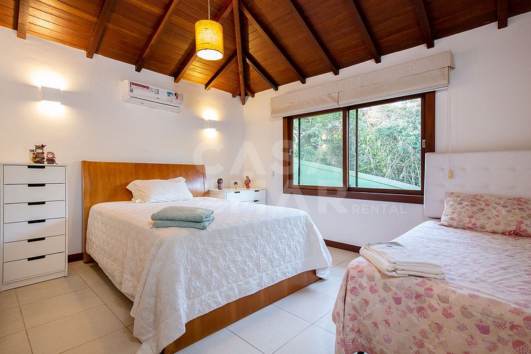 Casa com quatro suítes, sala de tv, piscina e churrasqueira.